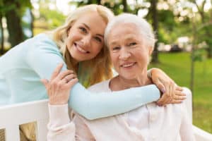 A young woman visiting her senior relative in an assisted living facility